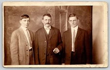 RPPC VINTAGE OLD ANTIQUE REAL PHOTO POSTCARD PICTURE FAMILY MEN FATHER SON SUIT