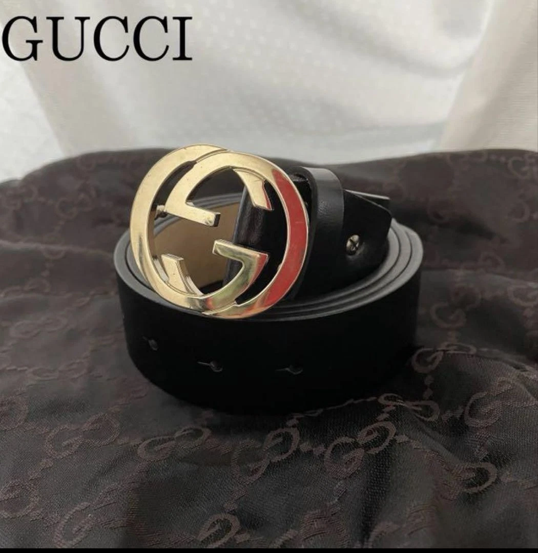 Ceinture Gucci imbriquée or noir boucle GG