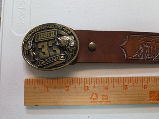 Zebco 33rd anniversary brass belt buckle with stamped brown leather belt