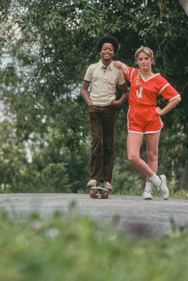 Todd Bridges wearing a beige short sleeve polo shirt and brown tro- Old Photo