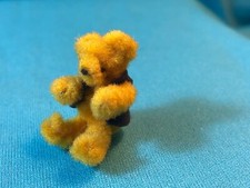 TINY 1" GOLD PLUSH COVERED WIRE TEDDY BEAR NOT JOINTED WEARING A BLACK VEST