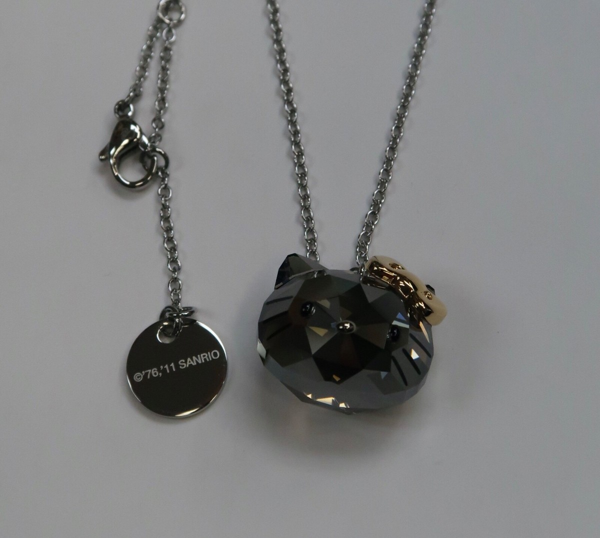 SWAROVSKI SANRIO HELLO KITTY CRYSTAL FACE JET GOLD RIBBON NECKLACE