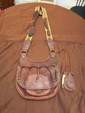 Mountain Man leather shoulder possibles pouch with patch knife sheath and more.