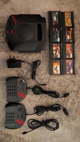 Boxed Atari Jaguar Console with 8 Games, spare controller and instructions.