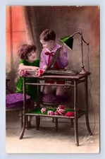 Kids Looking at Postcard or Photo Album RPPC Hand Colored Deltiology Photo 1932
