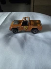 This is a vintage 1973 Hot Wheels Redline Baja Bruiser diecast truck in orange!