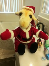 Geoffrey stuffed animal in Santa Suit
