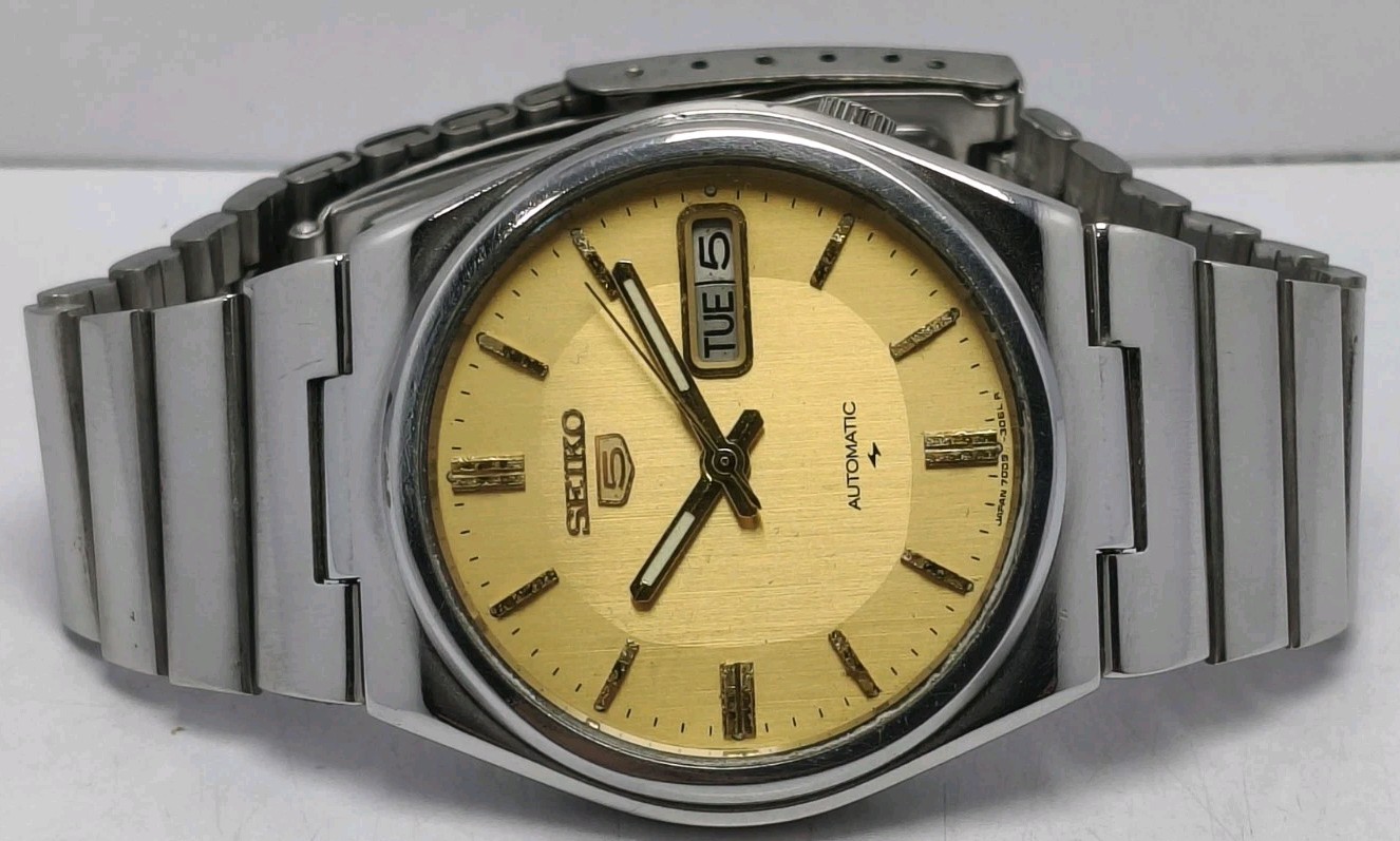 Vintage Seiko 5 jewels 7009 automatic watch with silver case and golden dial