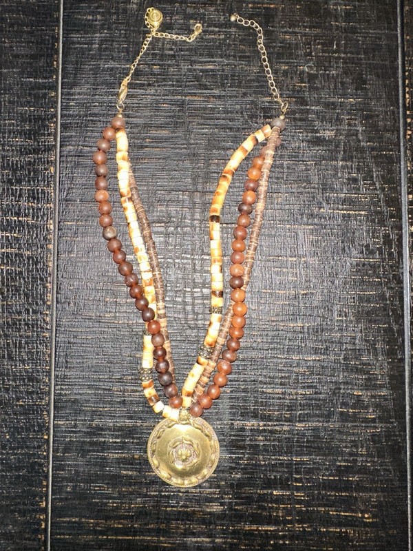 Multi Strand Beaded statement necklace featuring a large bronze-toned pendant