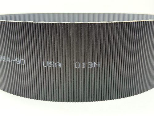 Black GATES 14MGT-994-90 poly chain belt with vertical ribbed pattern, white printed text reading “USA 013N” on black.