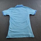 Light blue short-sleeve polo shirt with white sleeve trim, three-button placket, and blue Aston Martin logo on back.