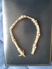 14ct gold bracelet set with seven oval Tanzanite stones. Bracelet weighs 18g