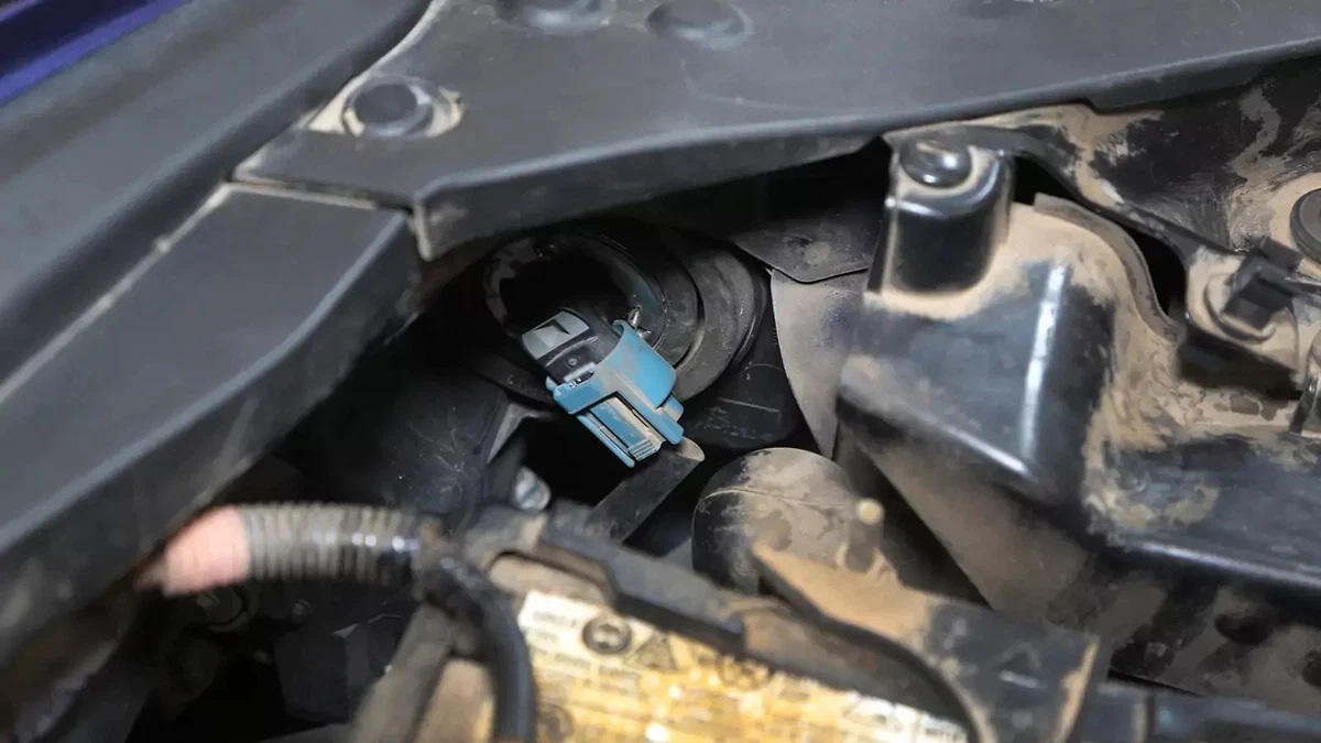 The headlight bulb from the inside of the car, under the hood.