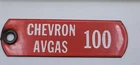 Vintage Chevron Avgas 100 Rustic Porcelain Metal Gas Pump Tag
