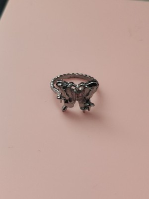 A silver Butterfly Y2K Ring with Mini Star Shaped Prints On It.