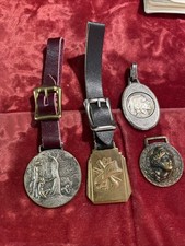 Quatre anciens porte-montres Battle Creek, pompier, buffle nickel et visage femme
