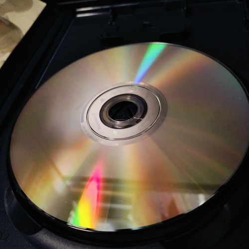 PS2 Shadow of Memories Konami disc with rainbow gradient and silver center label on black background.