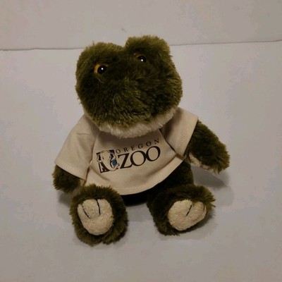 Small green frog plushie with orange eyes and Oregon Zoo shirt 