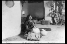 A Moki potter,Oraibe,Hopi woman on floor with pottery,Arizona,AZ,c1900