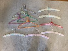 Set of 11 vintage handmade crochet coat hangers.