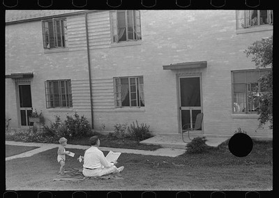 Photo:Greenbelt Maryland 1938 Father and Son Reading Outside House