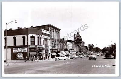 K53/ St Johns Michigan RPPC Postcard c40-50s Main Street Stores Autos 326