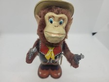 VINTAGE 1950's T.N. NOMURA WIND UP MECHANICAL SHOOTING COWBOY MONKEY