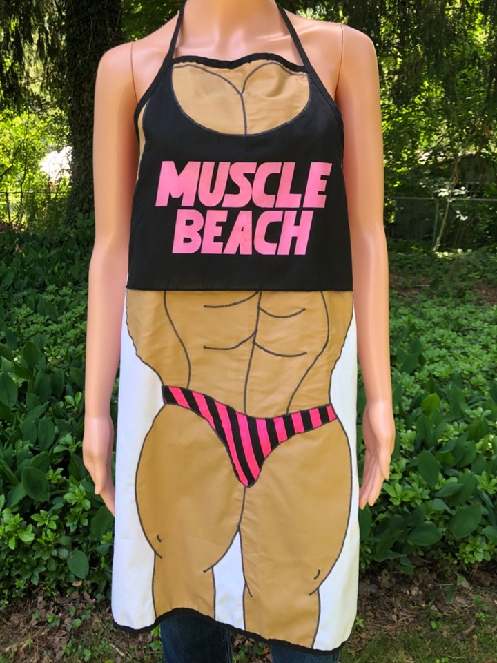 A genuine 90s Muscle Beach novelty apron with bodybuilder graphics — absurdly fun BBQ gear that doubles as a conversation-starting piece of LA pop culture history.