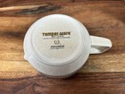White ceramic mug with “Temper-Ware” logo, brown side handle, and embossed text “Made in U.S.A.”