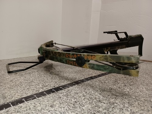Green and brown camouflage Barnett QUAD-300 System 4 crossbow with black accents and visible orange graffiti-style text.