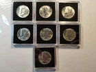 7 Each 1964 Kennedy Half Dollar BU To AU 90 % Silver Coins. Encapsulated
