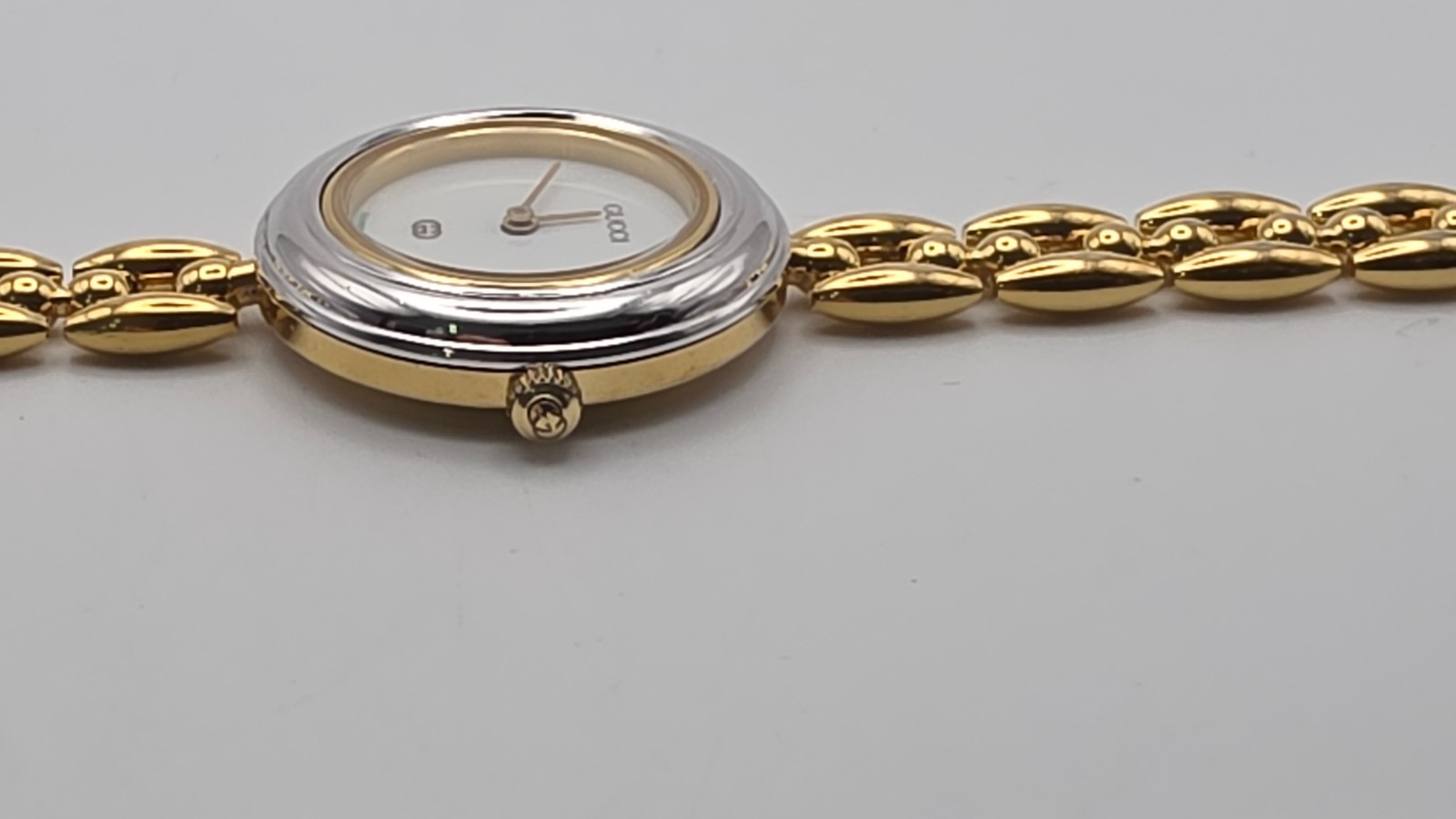 Gucci 1100L  Lady's Gold Plated Bracelet Watch with Six Interchangeable Bezels.