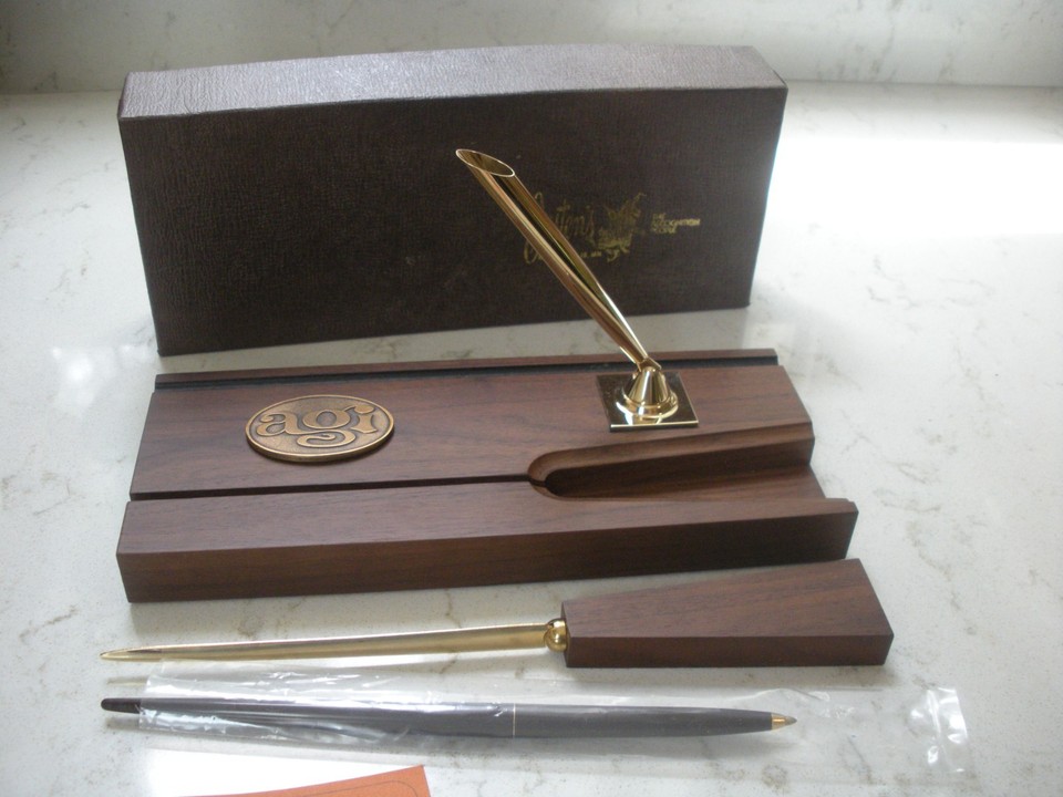 A NOS Josten's/AGI walnut MCM desk set with a Sheaffer pen still new — deadstock mid-century office goods with genuine collector appeal.