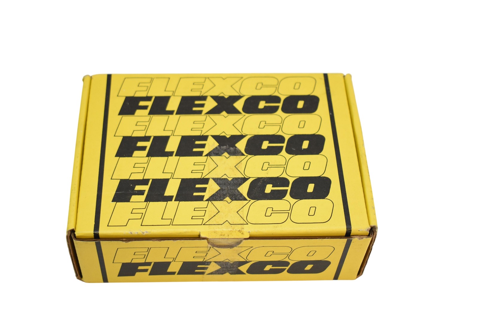 Yellow Flexco box with black logo and text, made in USA, showing multiple rows of black “FLEXCO” lettering.