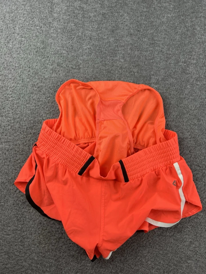 Pantalones cortos para mujer Reebok forrados en naranja talla pequeña de 2" Foto 3 de 4