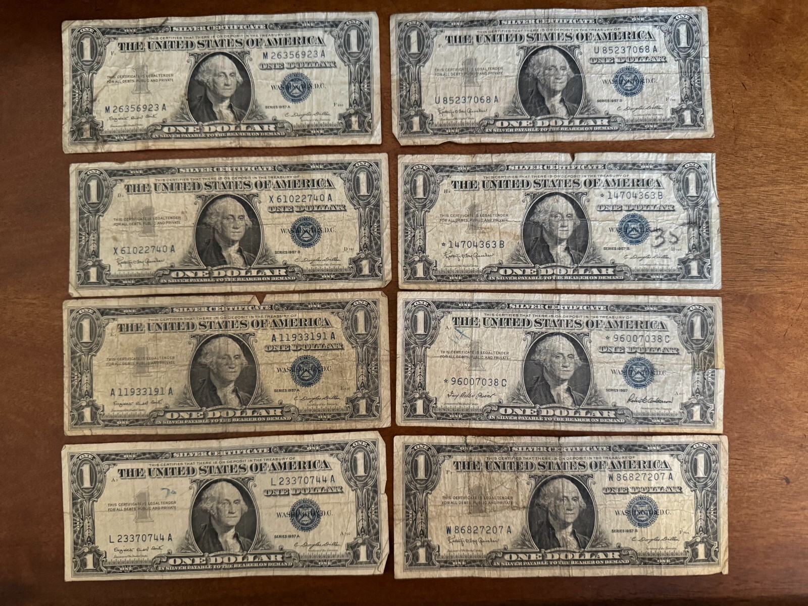1957 $1 SILVER CERTIFICATE CURRENCY NOTE LOT OF 8. INCLUDES TWO STAR ...