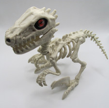 NEW 9" LONG SKELETON DINOSAUR - RAPTOR W/ RED, GREEN AND BLACK EYES