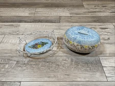 Temp-tations Ovenware by Tara Blue oval covered casserole dish with a metal stan