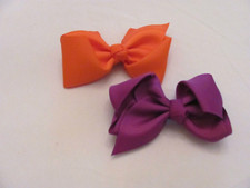 NWOT SET OF 2 GIRL'S BOWS WITH SILVER CLIPS-SOLID ORANGE  SOLID PURPLE
