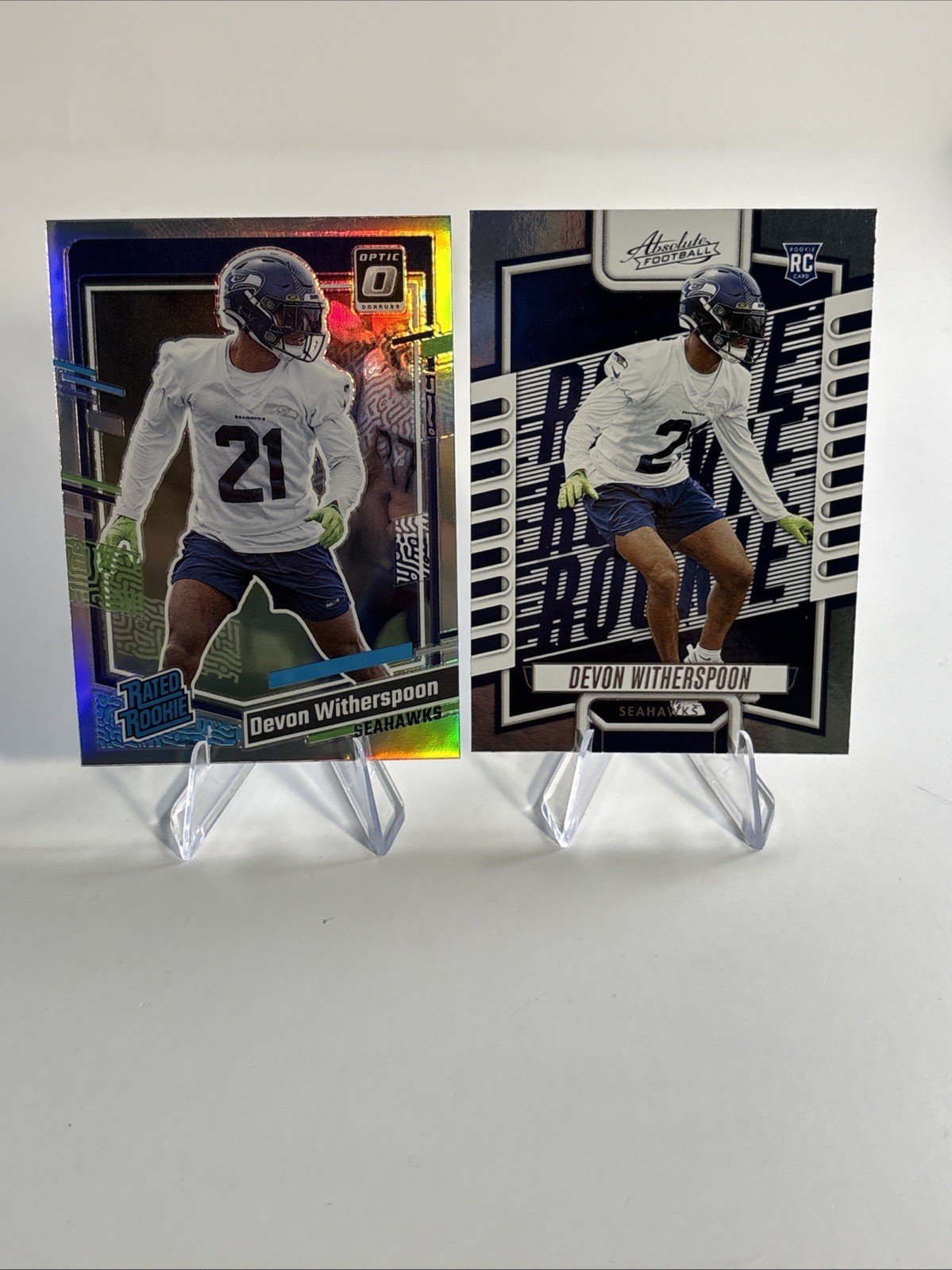 2023 Donruss #389 Devon Witherspoon Optic Rated Rookie Holo Prizm & 2023 #146