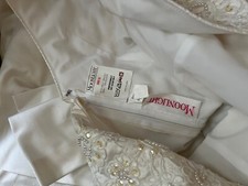 wedding dress  size 12 never worn. Also  comes with a vail. Also never worn.  