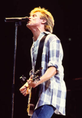 Canadian Rock musician Bryan Adams plays guitar as he performs duri Old Photo 6