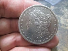 1885 S MORGAN SILVER DOLLAR IN ABOUT UNCIRCULATED CONDITION CLEANED
