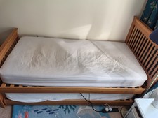 Single Wooden Bed With Second Single Trundle Bed Stores Underneath.
