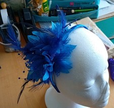 A  two tone blue Fascinator With Beads, Flowers & Feather detail on a headband