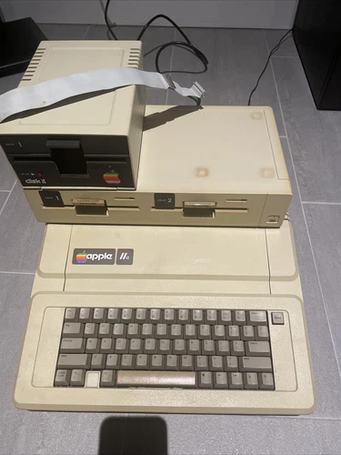 Apple IIe computer system with single disk and dual disk drives +books