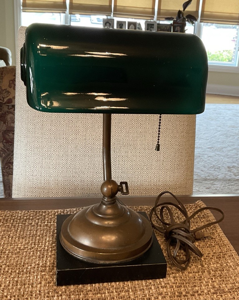 A working 1917-patented Verdelite brass banker's lamp with original green cased glass shade — a certified piece of American desk history that still lights up.
