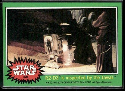 1977 Topps Star Wars #228 R2-D2 is inspected by the Jawas