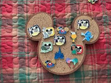 A lot of 12 Disney trading pins from 2025
