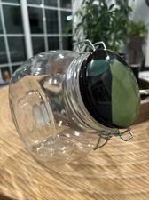 8”Round Tilted Glass Jar With Decretive Lid with A Pear Decoration 8”x 7.5”x 5.5